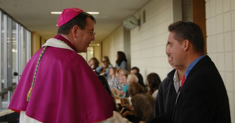 Archbishop Vigneron greets members of the Mercy community before the prayer service and blessing begins.