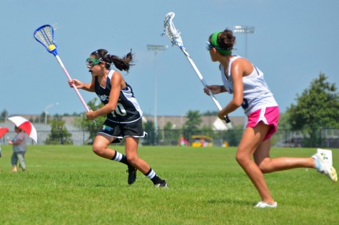 Sophomore Brooke Ottaway speeds past a defender in a tournament for the Detroit Coyotes.
Photo credit: Liz Ottaway