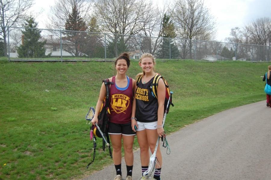 Varsity lacrosse players, junior Tori Sullivan (left) and senior Allie Shaw, grin after an exhausting practice. Photo credit: Anjali