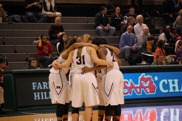 Some Mercy varsity basketball players huddle together during a timeout at The Breslin Center. The ladies fell in the State Semifinal to rival Marian, 67 to 55.