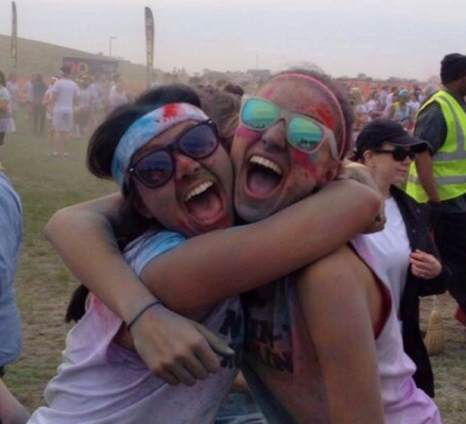 Although junior Hannah Lesko (left) takes competitive running very seriously, she enjoys participating in runs designed for fun, such as the Color Me Rad race in Detroit, which she completed with her friend Lauryn Hauncher (right) this past summer. Fun runs make running more of a social event, said Lesko. It is good for me to take a break from the super intense runs every once in a while (Photo Credit: Allia McDowell). 