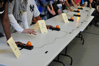 At a quiz bowl tournament, the students must ready themselves to answer questions with their hands poised above the buzzer. (Photo permission from Creative Commons Flickr. Photo Credit: Karen Blumberg). 