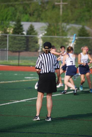 An MHSAA referee makes calls at Mercy's regional tournament game against Farmington (Photo credit: Ann Blake).