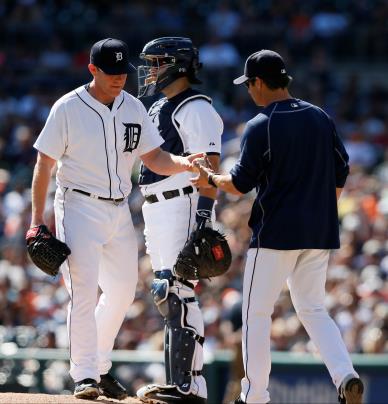 Pitcher Randy Wolf gives manager Brad Ausmus the ball during a home game against the Minnesota Twins. The Detroit Tigers close their season on Sunday, Oct. 4 against the Chicago White Sox. (Photo credit: Julian H. Gonzalez)