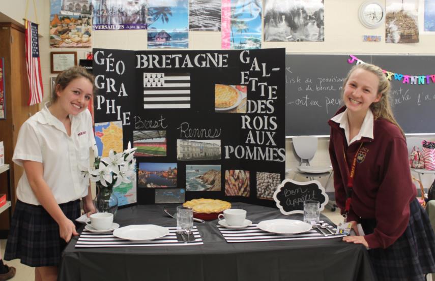 Sophomores Grace Denomme and Mary Doman present their gallette aux rois des pommes in Madame Campbell’s room. (Photo credit: Alana Sullivan)