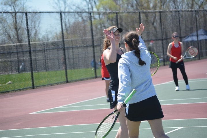 Although two doubles players Carly Demkowicz and freshman Jacqueline Hijaouy lost their match, they still managed to keep a positive attitude. (Photo credit: Roxana Hijaouy)