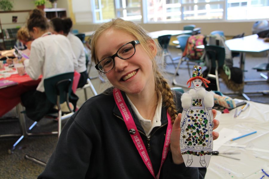 Sophomore Nathalie Gijsbers shows off the santon she created during the meeting. (Photo Credit: Karina Lloyd)