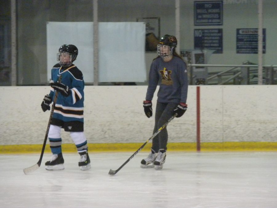 Junior Elena Ervin skates next to a MORC Star player during the learn-to-skate session. (Photo Credit: Shannon Seabolt)