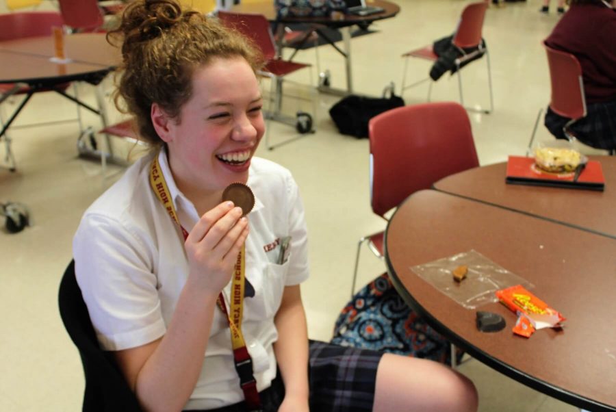 Freshman Emily Guerrera enjoys a Reeses chocolate before giving up sweets for Lent. (Photo Credit: Caitlin Jefferson)