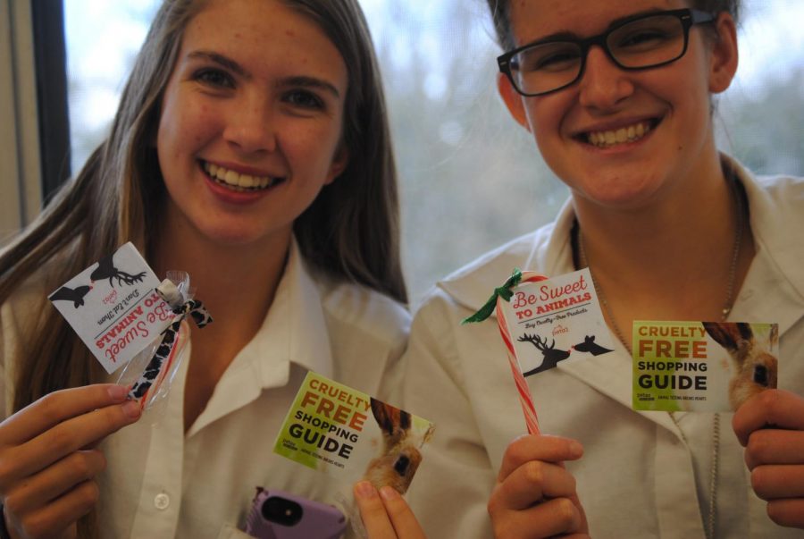 Members of Animal Rights Club show off their gift guides and candy canes urging others to think twice about how their holiday gifts are made. (Photo Credit: Megan Hutter)