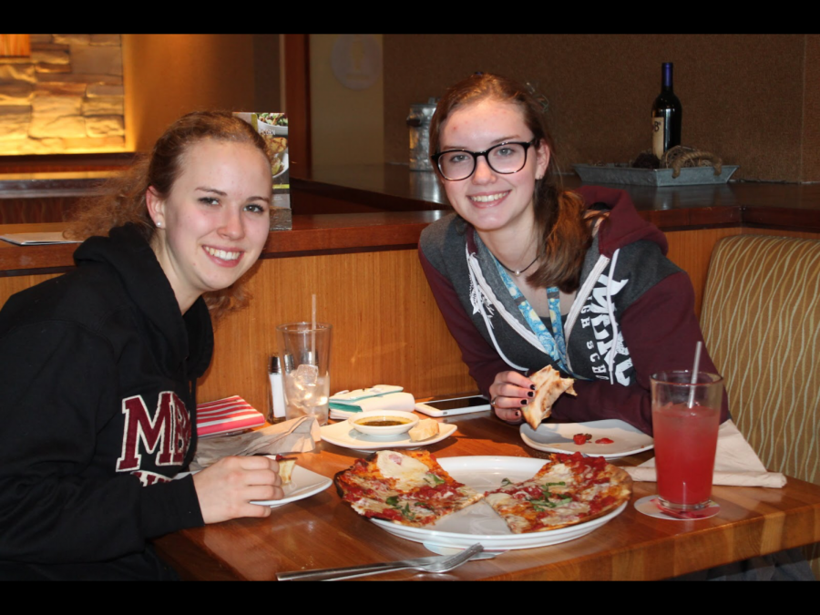Seniors Kathryn Wolf (left) and Mackenzie Farrow split a margherita pizza, a CPK classic, while supporting Mercy through spirit wear and their bill. 