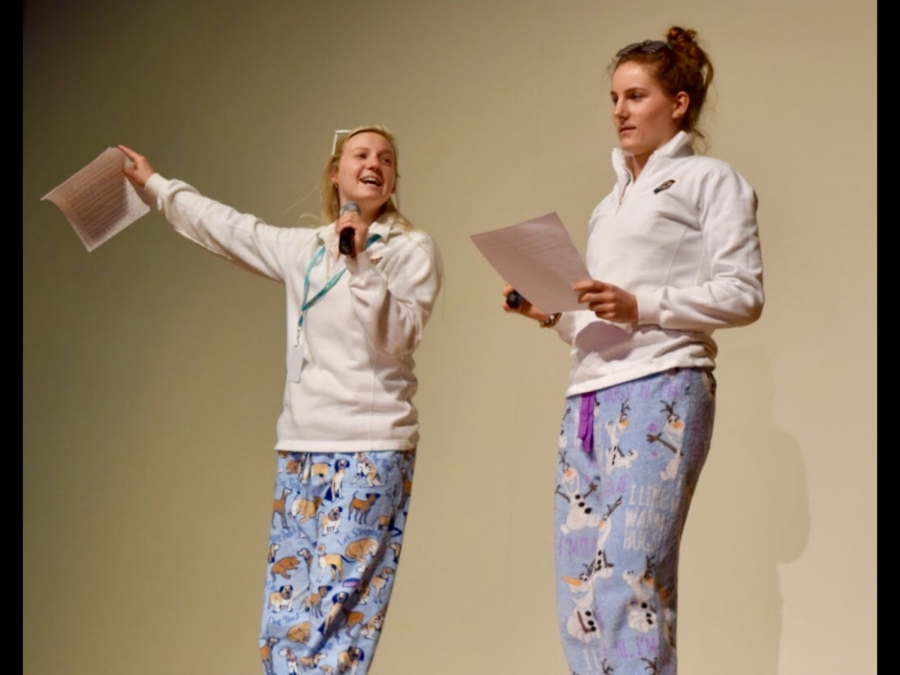 The Student Council president, senior Mary Doman, along with Sweepstakes committee member and senior officer Catie Coffman, encourage students to sell Sweepstakes tickets at the assembly after the conclusion of the MTV-themed video.