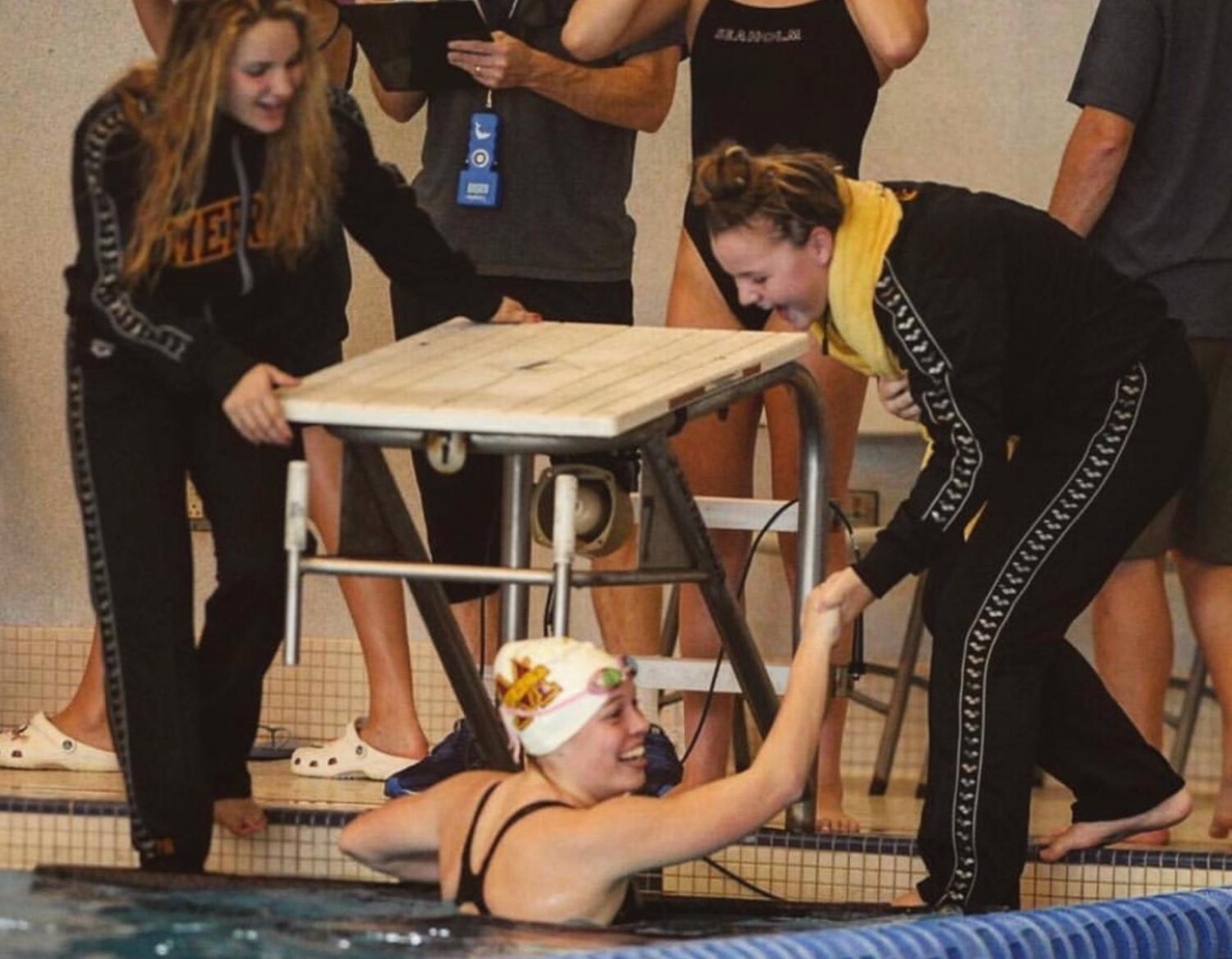 Junior Emily Guerrera is congratulated after a race by teammates Sarah Puscas (left) and Lindsey Case (right).
Fair use: photo from Instagram