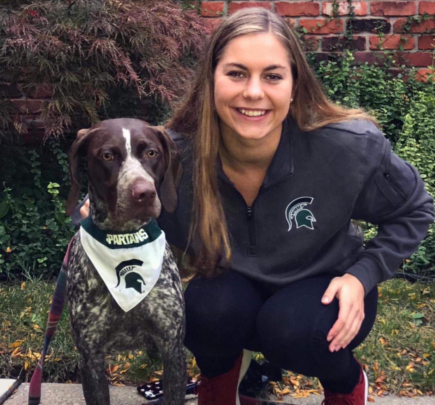 Dombkowski smiles with her dog in MSU gear, showing her excitement to start this new journey. Photo used with permission from Annette Dombkowski