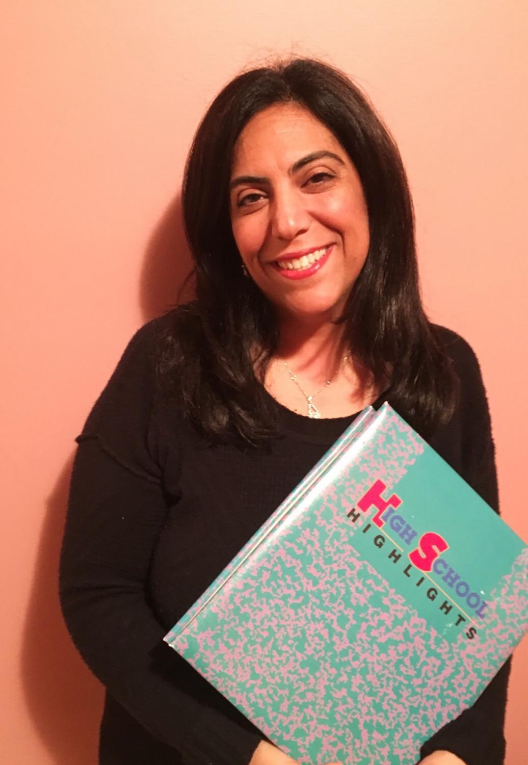 Thomas displays her High School Highlights scrapbook that she made when she graduated from Mercy in 1991.
Photo by: Sabrina Yono