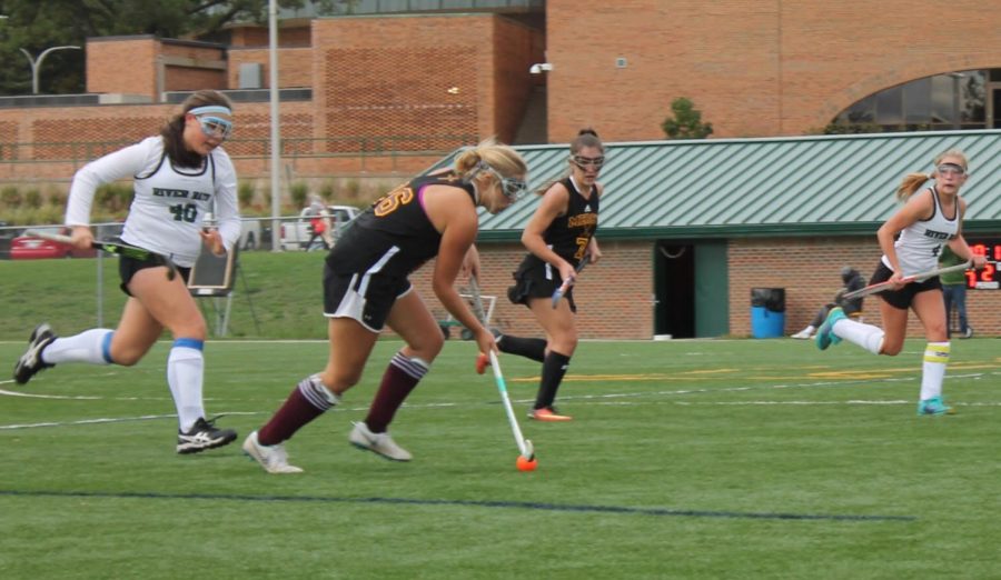 Senior Sarah Cassidy dribbles past the defense in one of her last field hockey games at Mercy.
Photo by Keiley Black