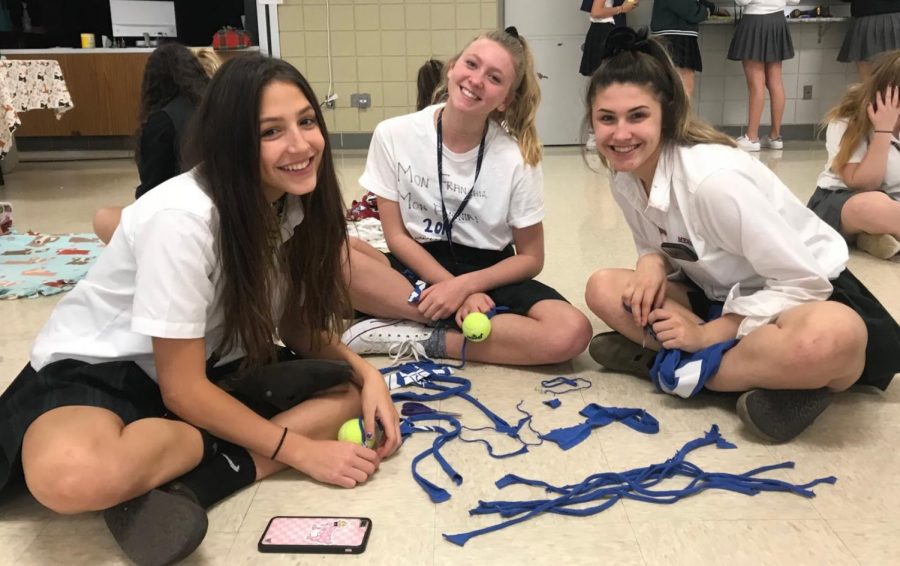 Sophomores Sofia Genrich, Caroline Wiseley, and Ashley Phillips work on making toys for shelter dogs during their most recent club meeting. 
Photo used with permission from Eli Lyons 