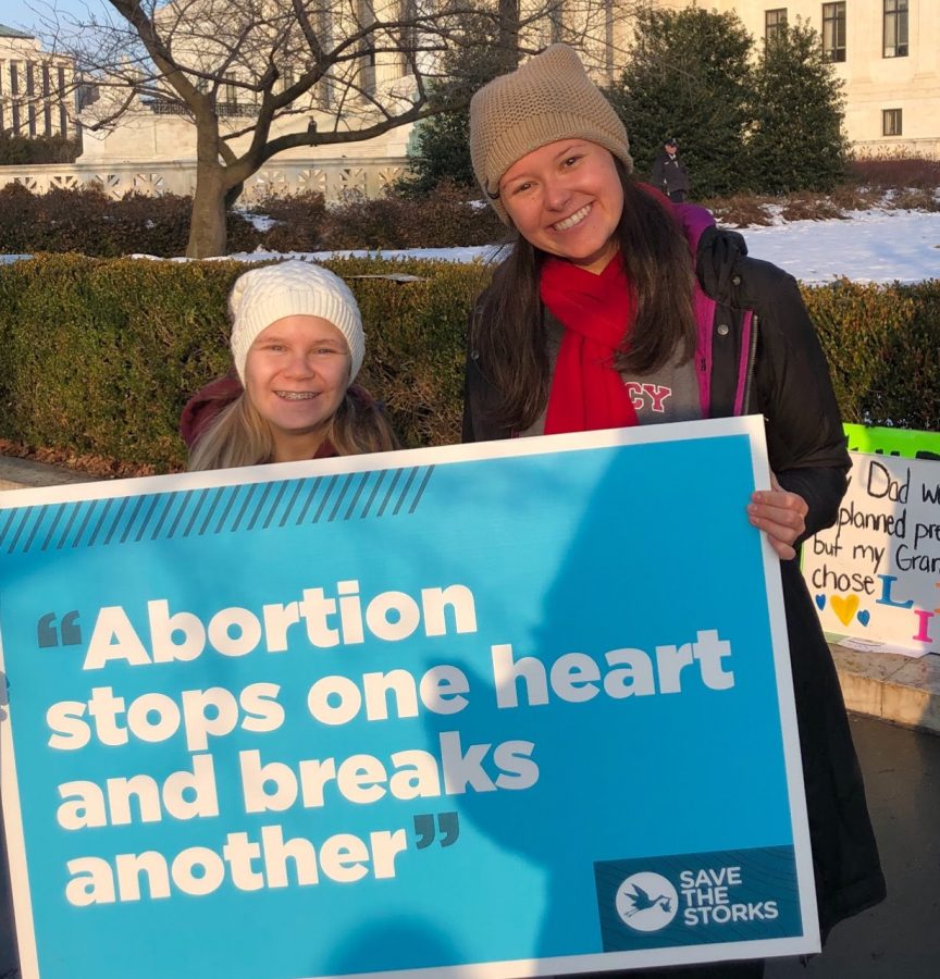 Fadool (right) stands with a pro-life poster in front of the Supreme Court Building, the final destination of the March for Life. 
Photo used with permission from Grace Fadool