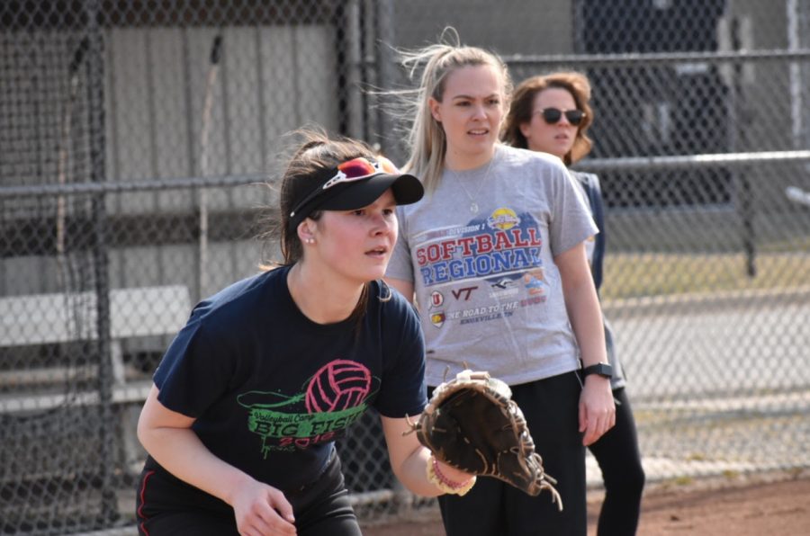 Junior Emma Dompierre (left) prepares to catch a ball coming her way while her new coach, Kayce Nieto (middle), observes. Photo by Caitlin Flynn
