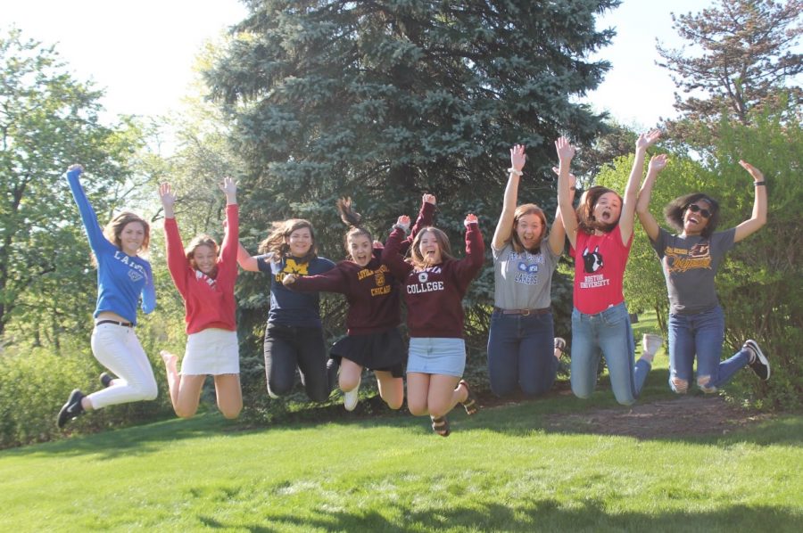 Newsprint seniors: Grace Fisher, Skyler Black, Melissa Kurpiers, Alley Neary, Alyssa Johnston, Abbey Roegner, Colleen Tomson, and Jada Gordon (left to right),  jump as they celebrate their last week together. Photo by: Priyanka John