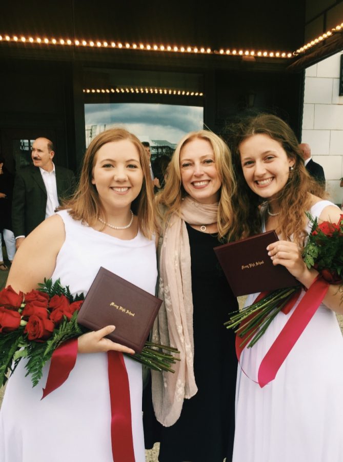 Teacher of the Year Ms. Lisa Wilson smiles with former A.P. Biology students Abbey Roegner (left) and Katie Bullock (right) one final time after the 2019 graduation ceremony. Photo used with permission from Diane Roegner 
