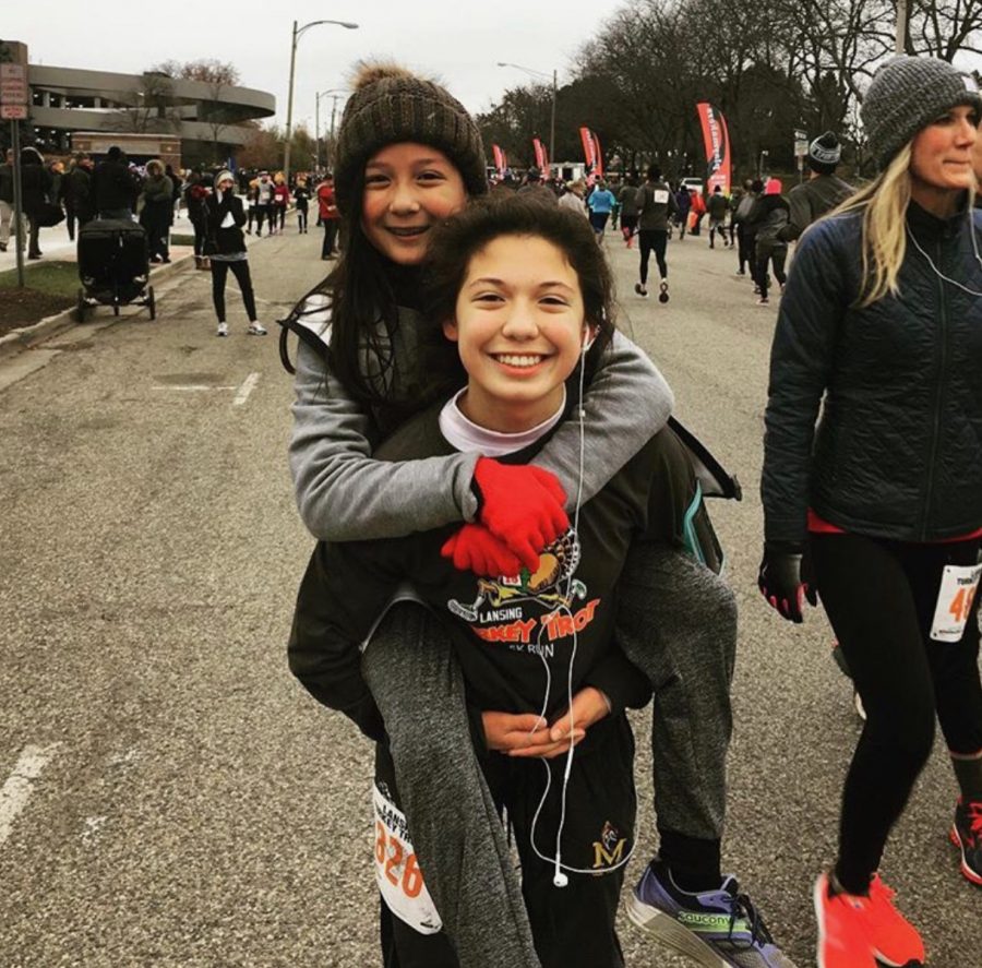 Junior Katie Kim and her younger sister Grace Kim at the Turkey Trot in 2018. The Turkey Trot is a 10K that runs on Thanksgiving morning and has been a family tradition for the past 35 years. Photo used with permission from Katie Kim 