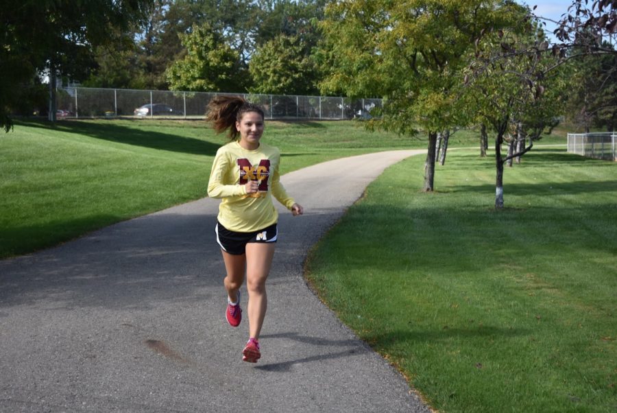 Gabby Pluszczynski runs around the Mercy fields during a cross country practice. Photo by Isabelle Sawicki
