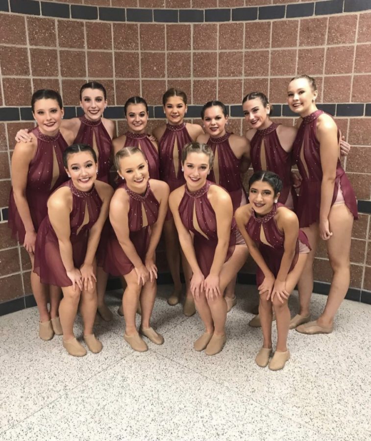 The Mercy Varsity dance team poses in their costumes as they prepare to compete. Photo used with permission from Brittany Burns