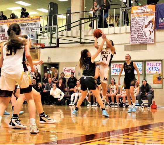 The gymnasium was full of excitement as Mercy Varsity Basketball (MVB) started off the new year strong by beating their Marian rivals. Photo by Julia Canty