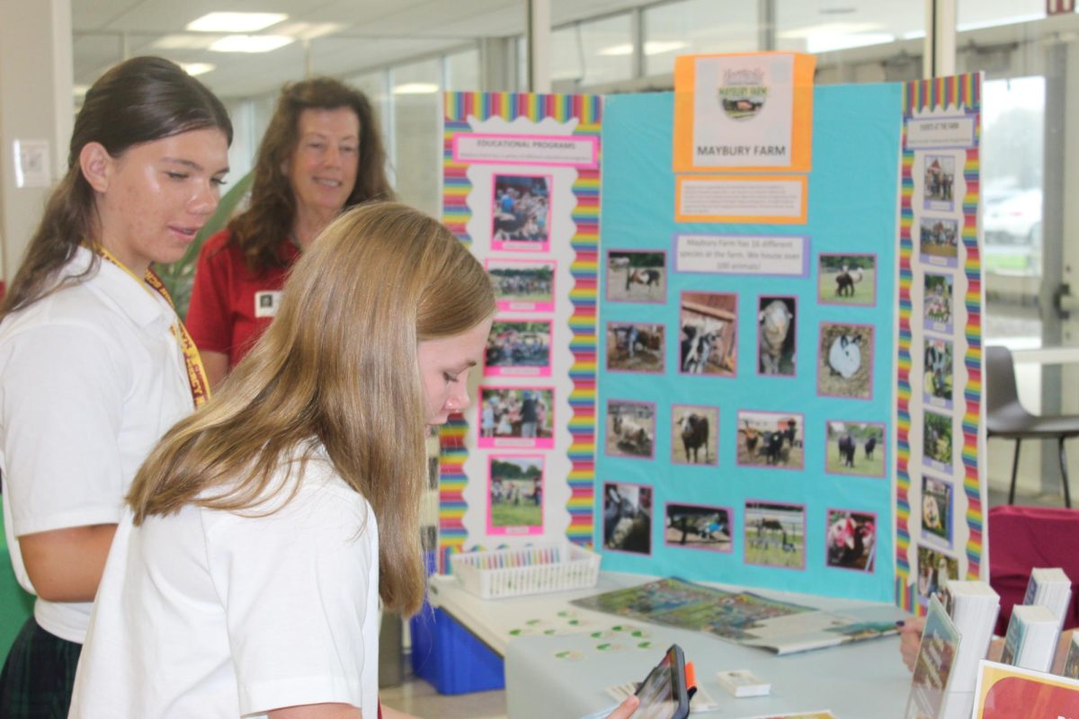 Mercy student signs up for a new service opportunity during the Community Connections Fair.