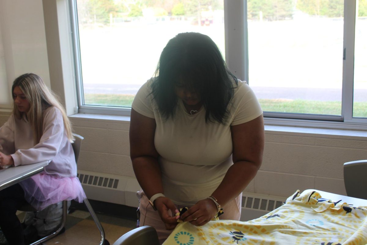 Junior London Burke works on blanket for Make A Difference Day.