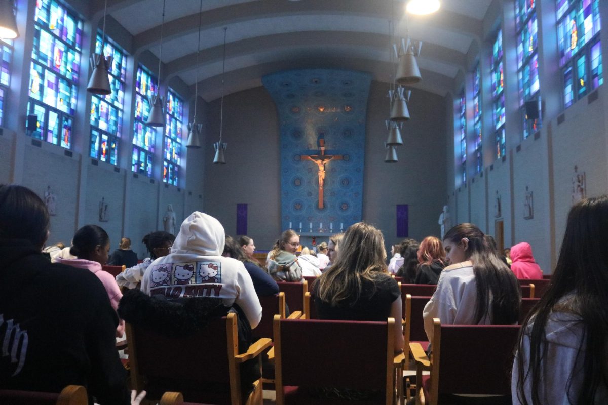 Students sit in the chapel before they begin the retreat. 