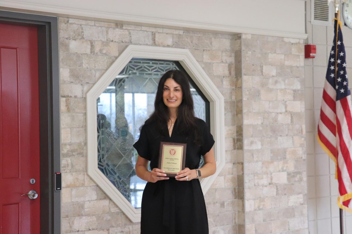 Mrs. Cilona poses with her Teacher of the Year award.