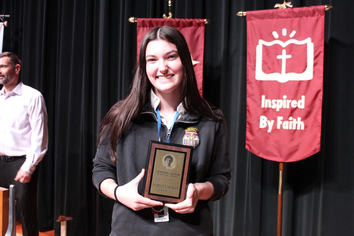 Isabelle poses with her Emily George plaque.